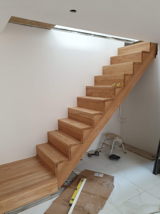 Bespoke solid oak staircase manufactured in Poland with 40mm thick wood and satin sprayed finish
