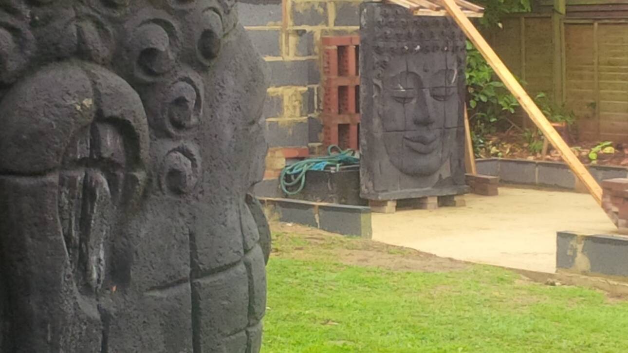 Installation of 1-tonne Buddha statues from Bali as part of a Grand Design–style garden and glass extension project in Brookmans Park by Optima Builders