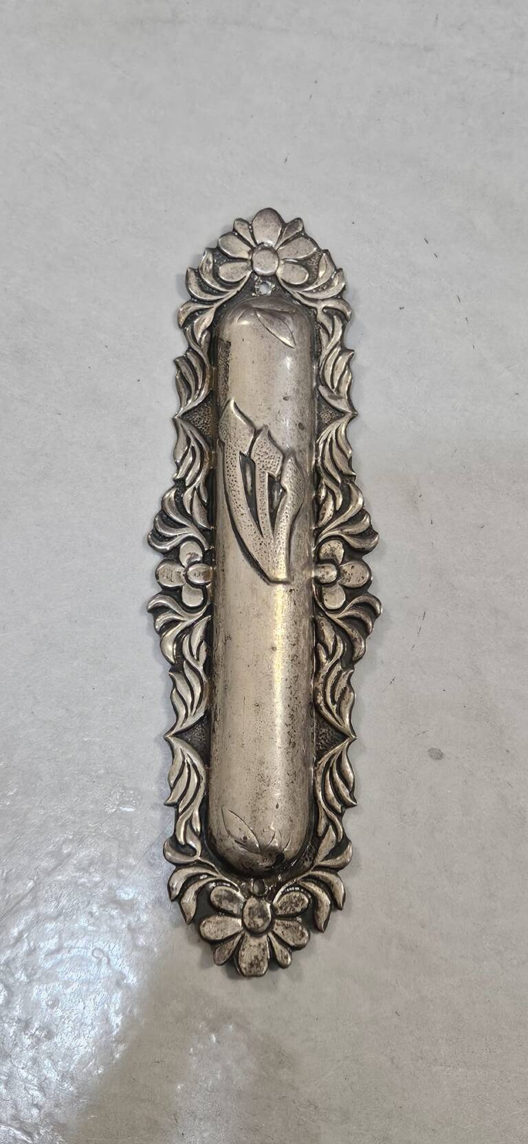 Vintage metal mezuzah case with Hebrew Shin symbol and ornate floral detailing